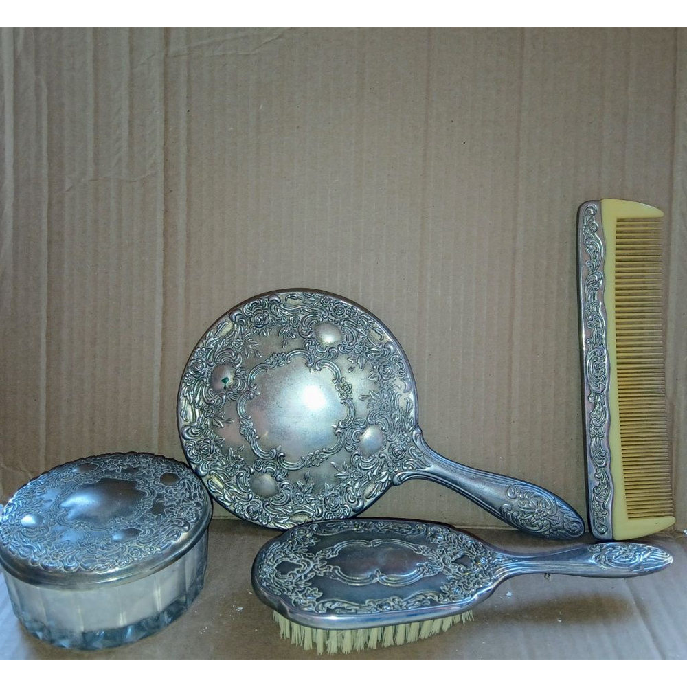This antique silver plated vanity set exudes old-world charm